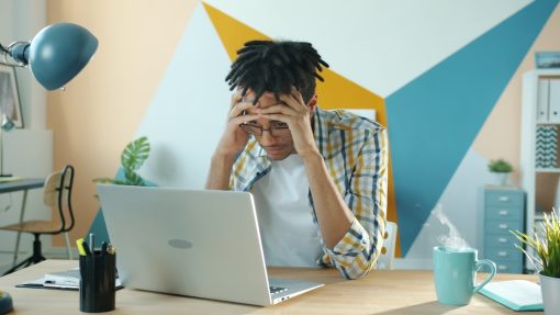 frustrated person with computer due to site blocking laws and streaming issues